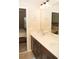Bathroom with dual sinks, modern fixtures, and an open doorway to an adjacent room or bedroom, creating a functional layout at 2260 Rapollo Dr, Kissimmee, FL 34741