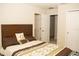Comfortable bedroom featuring a wooden headboard, decorative pillows, and a patterned bedspread next to a closet at 2260 Rapollo Dr, Kissimmee, FL 34741