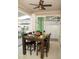 Covered patio dining area with dark wood table, ceiling fan and sliding glass doors at 2260 Rapollo Dr, Kissimmee, FL 34741