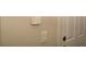 This hallway features a wall-mounted security panel and a white door, offering security and peace of mind at 2260 Rapollo Dr, Kissimmee, FL 34741