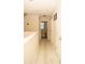 Hallway with neutral paint and flooring with multiple door access to rooms at 2260 Rapollo Dr, Kissimmee, FL 34741