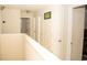 Upstairs hallway with multiple doors, trim and light neutral paint at 2260 Rapollo Dr, Kissimmee, FL 34741