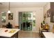 Bright kitchen featuring tile flooring and a sliding door to the backyard at 2260 Rapollo Dr, Kissimmee, FL 34741