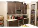 Kitchen featuring stainless steel appliances, dark brown cabinets and a pantry at 2260 Rapollo Dr, Kissimmee, FL 34741