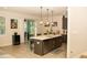 Open-concept kitchen features a large island, stainless steel appliances, and pendant lighting at 2260 Rapollo Dr, Kissimmee, FL 34741