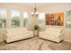 Bright living room featuring two white couches, multiple windows, and neutral colored walls at 2260 Rapollo Dr, Kissimmee, FL 34741