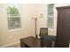 Bright home office features large windows with blinds, desk, chair, and plenty of natural light at 2260 Rapollo Dr, Kissimmee, FL 34741