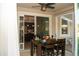 Outdoor patio dining area with views into kitchen, ceiling fan, and sliding glass doors to the outdoors at 2260 Rapollo Dr, Kissimmee, FL 34741