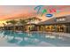 Stunning pool with palm trees reflecting in the water, adjacent to the clubhouse, ideal for relaxation at 2260 Rapollo Dr, Kissimmee, FL 34741