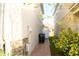 Narrow side yard features a brick pathway, utility access, and partial fencing at 2260 Rapollo Dr, Kissimmee, FL 34741