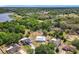 Aerial view showcases a home with a spacious, fenced-in yard nestled among lush trees at 2617 Greywall Ave, Ocoee, FL 34761