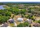 Aerial view shows a home with a fenced yard, surrounded by trees in a quiet neighborhood at 2617 Greywall Ave, Ocoee, FL 34761