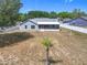 Aerial view of the backyard showing a lovely blue home, white fence and sparse landscaping at 2617 Greywall Ave, Ocoee, FL 34761