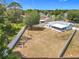 View of the backyard with a lovely blue home, white fence and sparse landscaping at 2617 Greywall Ave, Ocoee, FL 34761