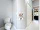 Bathroom featuring a toilet, linen closet, and magazine rack with storage at 2617 Greywall Ave, Ocoee, FL 34761