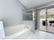 Bathroom features a large soaking tub and a separate enclosed shower at 2617 Greywall Ave, Ocoee, FL 34761
