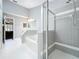 Bathroom with a large soaking tub and tiled shower and white flooring at 2617 Greywall Ave, Ocoee, FL 34761