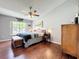 Comfortable bedroom with hardwood floors, ceiling fan and natural light at 2617 Greywall Ave, Ocoee, FL 34761