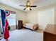 Cozy bedroom with neutral walls, ceiling fan, window, closet, and carpeted floor at 2617 Greywall Ave, Ocoee, FL 34761