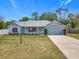 Charming single-story home with a well-manicured lawn and a one-car garage at 2617 Greywall Ave, Ocoee, FL 34761