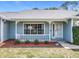 A cozy front porch with decorative trim, well kept flower bed and beautiful landscaping at 2617 Greywall Ave, Ocoee, FL 34761
