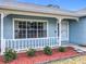 A cozy front porch with decorative trim, well kept flower bed and beautiful landscaping at 2617 Greywall Ave, Ocoee, FL 34761