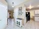 Hallway with tile flooring, wainscotting, and access to the kitchen at 2617 Greywall Ave, Ocoee, FL 34761