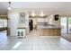 Hallway with tile flooring, wainscotting, and access to the kitchen at 2617 Greywall Ave, Ocoee, FL 34761