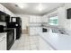 Eat-in kitchen featuring white cabinets and tile flooring at 2617 Greywall Ave, Ocoee, FL 34761