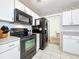 Kitchen featuring black appliances, and a tiled floor at 2617 Greywall Ave, Ocoee, FL 34761