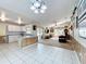 Open concept living area featuring tile flooring, wood-paneled walls, and a comfortable seating area at 2617 Greywall Ave, Ocoee, FL 34761