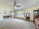 Spacious living room with large window, ceiling fan, and elegant furnishings at 2617 Greywall Ave, Ocoee, FL 34761