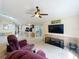 Spacious living room with vaulted ceiling, carpeting, and view of the kitchen at 2617 Greywall Ave, Ocoee, FL 34761