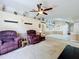 Cozy living room with vaulted ceilings, neutral carpet, and view of kitchen area at 2617 Greywall Ave, Ocoee, FL 34761