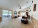Vaulted ceiling living room with sliding glass doors leading to outdoor patio space at 2617 Greywall Ave, Ocoee, FL 34761