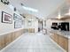 Open-concept living space with tile flooring, skylight, and a view into the kitchen at 2617 Greywall Ave, Ocoee, FL 34761