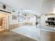 Bright open-concept living space with tile flooring, skylight, and view of the bathroom at 2617 Greywall Ave, Ocoee, FL 34761