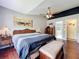 Spacious main bedroom with artwork, hardwood floors and comfortable bed at 2617 Greywall Ave, Ocoee, FL 34761