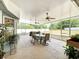 Screened-in patio with ceiling fans, a table with chairs, and a lovely backyard at 2617 Greywall Ave, Ocoee, FL 34761