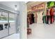 Bright walk-in closet with well-organized shelving and slider to the enclosed porch at 2617 Greywall Ave, Ocoee, FL 34761