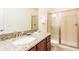Bathroom featuring granite countertops, vanity sink, and glass-enclosed shower at 291 Pendant Ct, Kissimmee, FL 34747