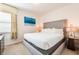 Bright bedroom featuring a gray platform bed, a contemporary painting, and neutral decor at 291 Pendant Ct, Kissimmee, FL 34747