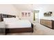 Cozy bedroom with a king-size bed, modern dresser, and world map artwork at 291 Pendant Ct, Kissimmee, FL 34747