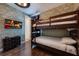 Fun bunk bedroom with wood floor, a brick-style wall, and a TV at 291 Pendant Ct, Kissimmee, FL 34747