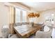 Elegant dining area with a large wooden table, seating for eight, and a large window for natural light at 291 Pendant Ct, Kissimmee, FL 34747