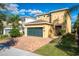 A two-story home with a brick driveway, two-car garage, well-manicured lawn, and neutral paint at 291 Pendant Ct, Kissimmee, FL 34747
