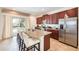 Spacious kitchen featuring granite countertops, stainless steel appliances, and a large island with seating at 291 Pendant Ct, Kissimmee, FL 34747
