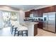 Open-concept kitchen featuring a large island with seating, stainless steel appliances, and sliding glass doors at 291 Pendant Ct, Kissimmee, FL 34747