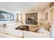 Bright living room with white sofas, large artwork, and a mounted TV on a decorative wooden panel at 291 Pendant Ct, Kissimmee, FL 34747