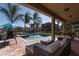 A beautiful in-ground swimming pool and hot tub, surrounded by lush landscaping and outdoor seating at 291 Pendant Ct, Kissimmee, FL 34747